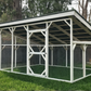 Large outdoor chicken coop with a roof in a backyard setting