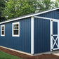 16x30 Blue storage shed with white trim in a backyard setting