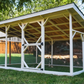 Wooden chicken coop with a roof in a backyard setting